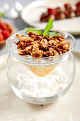 Chia pudding with thai mango and caramelized granola in glass bowl