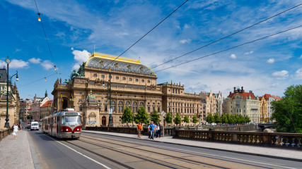 Legions Bridge and view of the road at Old Town part with historical buildings and Prague National Theatre.