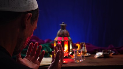 A Muslim man prays. During the entire month of Ramadan, Muslims are obligated to fast every day...