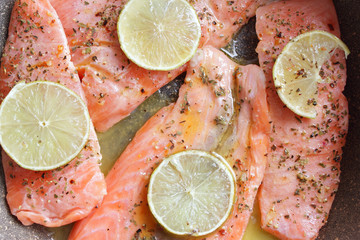 Salmon fillets ready to cook with lemon slices