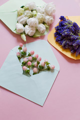 Blue, yellow and green envelopes with flowers inside