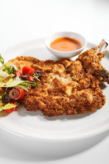 Meat chop in crispy breading close up