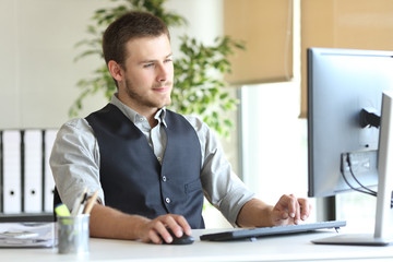 Concentrated executive using computer at the office