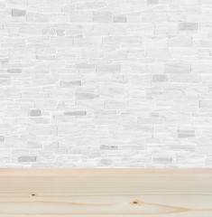 Empty brown wooden table or floor in front of white stone brick wall background of indoor interior design. Can be used for display or montage your product. Mock up for your design space.