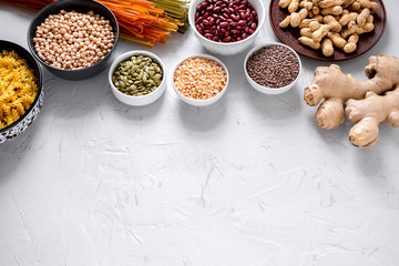 Pasta, lentils, Ginger Root, Chickpeas And Beans In Bowls Top View. Copy space.