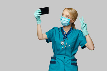 medical doctor nurse woman wearing protective mask and latex gloves - making video call on the phone