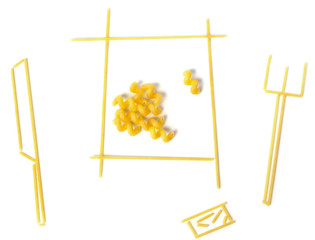 dish with macaroni, fork and knife from pasta isolated white