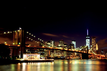 New York: Lower Manhattan through Brooklyn Bridge in night