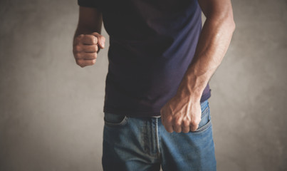 Caucasian angry man threatening with fist.