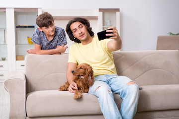 Young father and his son with cocker spaniel dog