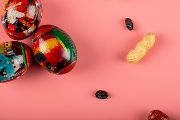 Traditional Novruz and Easter holiday decorated eggs isolated on pink