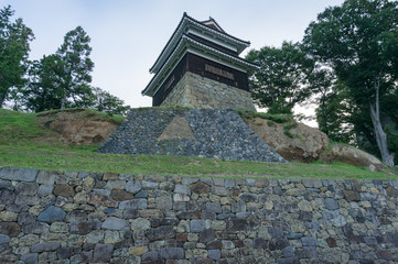 Traditional Japanese castle on stone hill. Ueda castle historic building