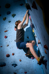 Teenage Boy Training On Climbing Wall