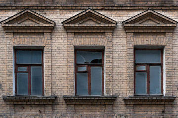 Fototapeta premium Fragment of the facade of an abandoned 19th century building with three windows