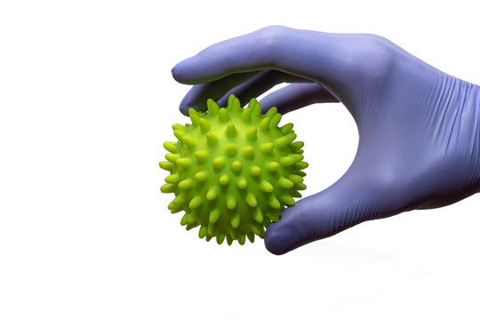 Hand in a blue medical glove with an abstract green virus isolated on white