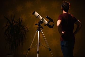 Amateur astronomer looking at the stars with a telescope. Astronomy and astrology concept.