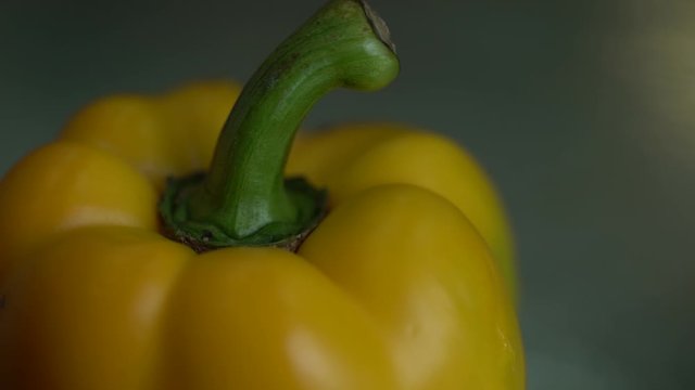 selective focus of yellow bell pepper skin gets blacked with the heat effect, vegetables on hot oven cooking concept in extreme close up 4K shot.