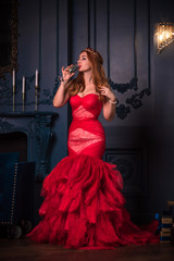 Redhead Woman in red luxury dress with feathers