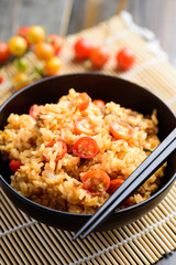 Fried rice with minced pork and tomato in a bowl and chopsticks ready to eating, Asian food