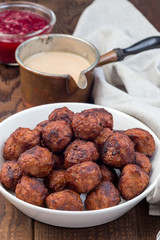 Meatballs served with cream sauce and cranberry jam, swedish cuisine, vertical