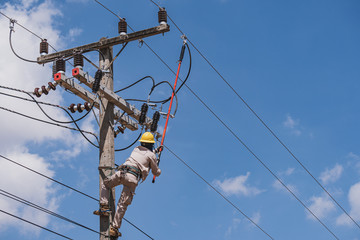 The power lineman use clamp stick (insulated tool) to closing a transformer on energized...