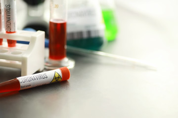 A blood sample for testing the dangerous virus coronavirus in the body. Test tubes with tests for coronavirus. Laboratory studies of viral diseases.