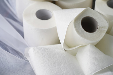 Toilet paper in a roll. Snow-white soft three-layer toilet paper. Lack of hygiene products. Primary protection and disinfection.