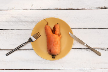 Ugly vegetables on white wooden table. Horizontal orientation, top view