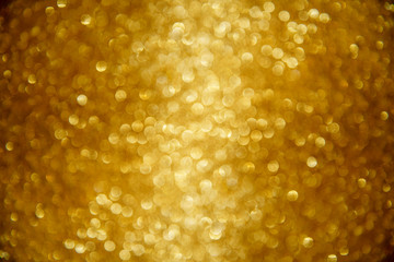 Gold glittering Christmas lights. Blurred abstract background