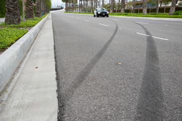 Left over skid marks from a street racing crash. (The police car was blurred on purpose)