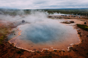 lake with boiling water in the valley of geysers of Iceland