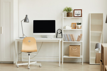 Clean background image of minimalistic apartment interior with focus on computer desk against white...