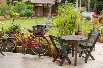 Fototapeta na wymiar Chair and bicycle in garden
