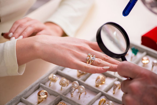 Young woman visiting old male jeweler - Powered by Adobe