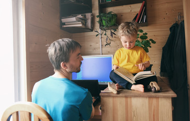 father freelancer try work from home and help son to read book, lifestyle workspace workplace,...