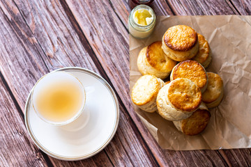 Top view a white cup of tea and Traditional British Scones on wooden table, breakfast food teatime .