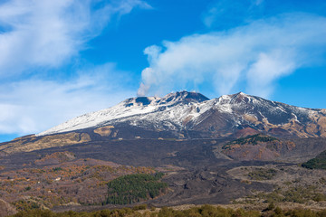 Mount Etna volcano with smoke and snow in winter. Catania, Sicily island, Italy, Europe