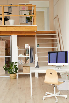 Vertical background image of contemporary two level office space with computer desk in foreground, copy space