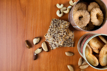 Ceramic coffee set in folk style close up. Juniper cup holder and coffee spoon. Fragrant coffee beans and brown sugar cubes. Coffee beans are scattered on a wooden table. Composition in warm colors.