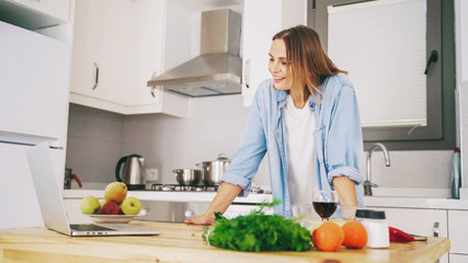 Young woman videoblogger cooking at the kitchen,  Food blog concept