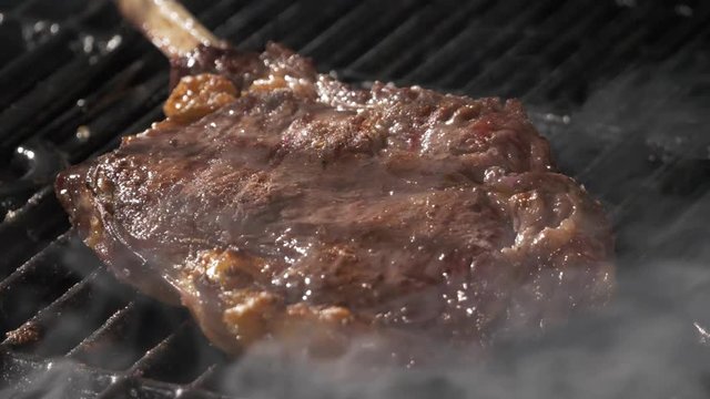 Tomahoawk Steak Sizzling On A Grill.