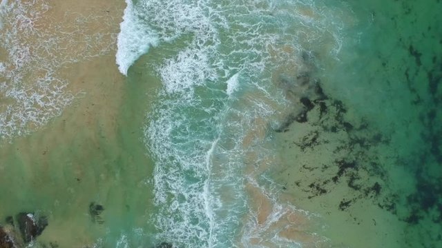 Beautiful Beach, turquoise water, in the north of Scotland. Sand, rocks and algue. Bird's eye view.