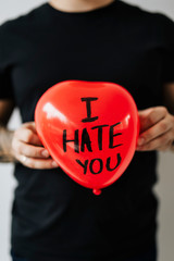 Man holding I Hate You balloon