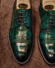 Close up of stylish green croco brogue shoe