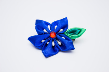 Blue handmade flower, hair clip isolated on a white background