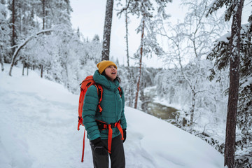 Woman trekking through a snow covered Lapland, Finland © rawpixel.com