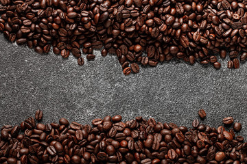 Coffee beans on dark concrete background with copy space. Top view. 