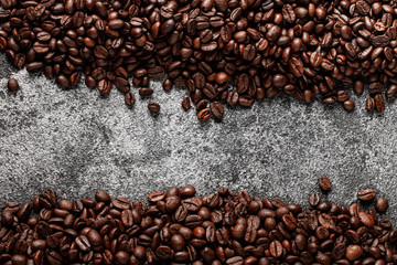 Coffee beans on dark concrete background with copy space. Top view. 