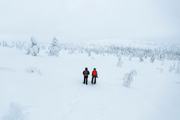 Naklejka na ściany i meble Drone shot of landscape photographers trekking in Lapland, Finland