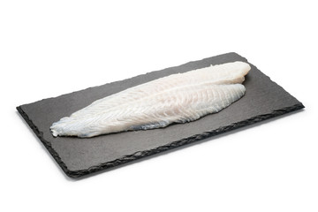 Basa fish fillet on a black stone plate, Isolated on white background.